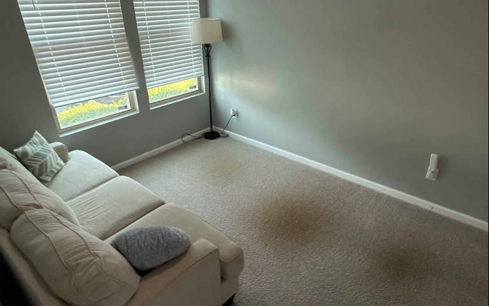 Stained light beige sofa before professional cleaning
